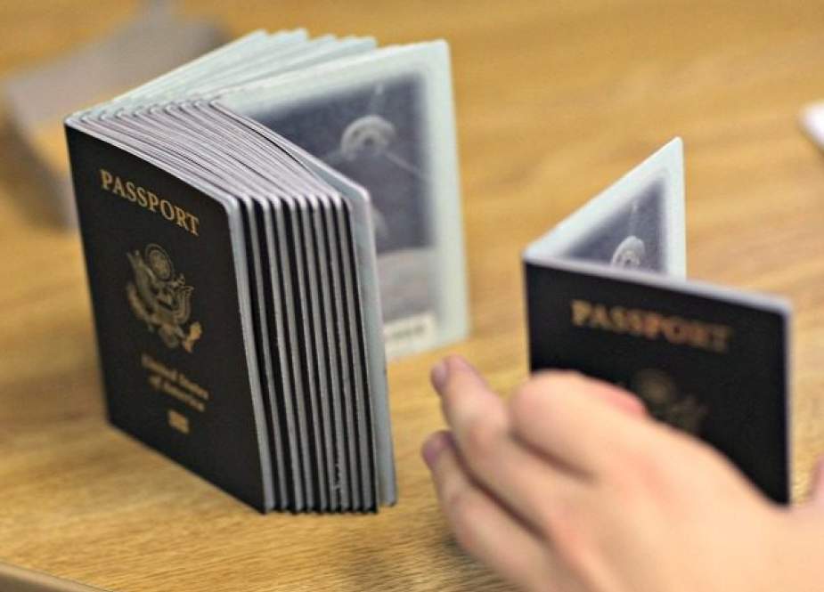 An American passport processing employee uses a stack of blank passports to print a new one at the Miami Passport Agency. (Getty Images file photo)