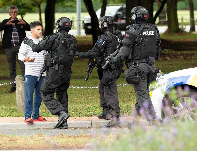 AOS (Armed Offenders Squad) push back members of the public following a shooting at the Masjid Al Noor mosque in Christchurch.