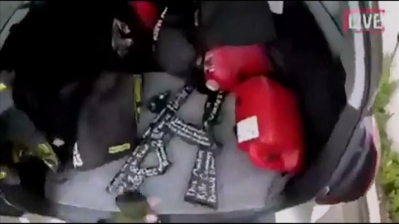 A still image taken from video circulated on social media, apparently taken by a gunman and posted online live as the attack unfolded, shows him retrieving weapons from the boot of his car in Christchurch.