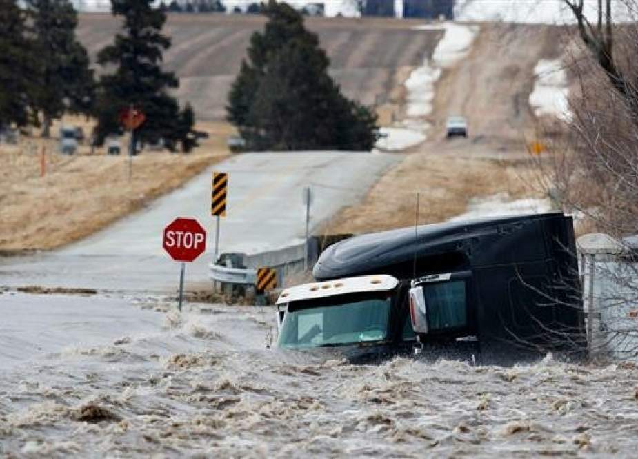 Trailer are swept off the road by floodwaters in Arlington, Nebraska.jpg