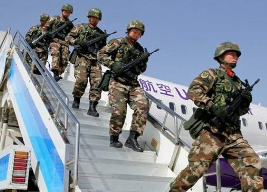 Chinese military police getting off a plane to attend an anti-terrorist oath-taking rally in Hetian, northwest China