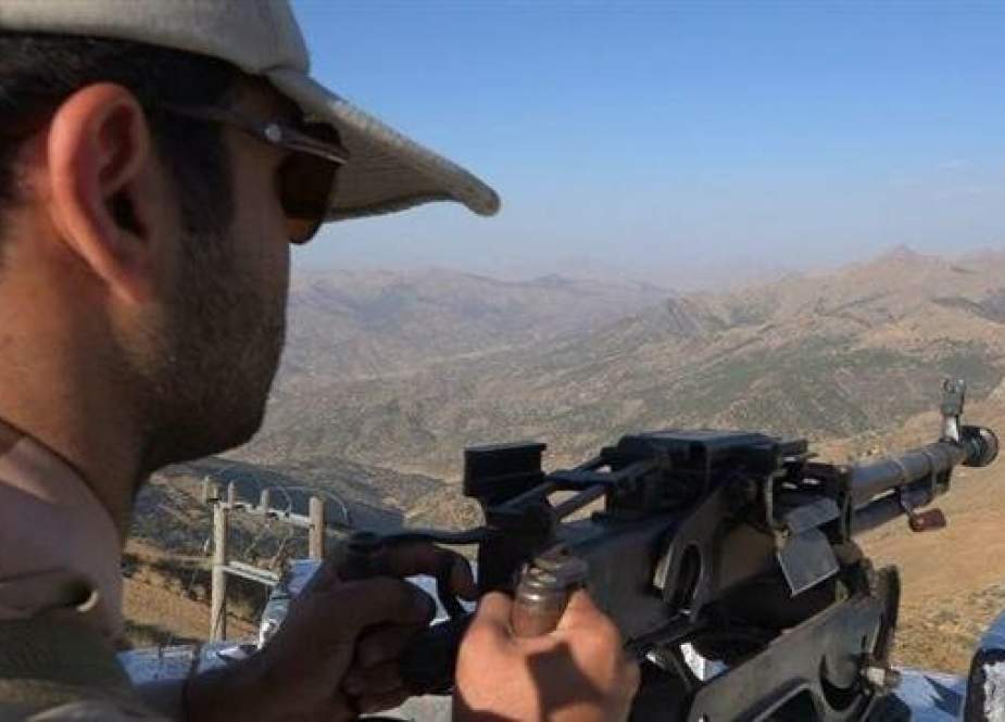 Iranian border guard keeps watch at the Chaleh-Pan border checkpoint in western Iran.jpg