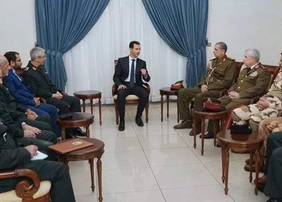 Syria’s President Bashar al-Assad (C) meets with Chairman of the Chiefs of Staff of the Iranian Armed Forces, Major General Mohammad Baqeri (5th-L) and Baqeri’s Iraqi counterpart Lieutenant General Othman al-Ghanimi (4th-R) in the presence of Syrian Defense Minister Ali Abdullah Ayyoub (3rd-R) in the Syrian capital Damascus on Monday, March 18, 2019. (Photo by SANA)