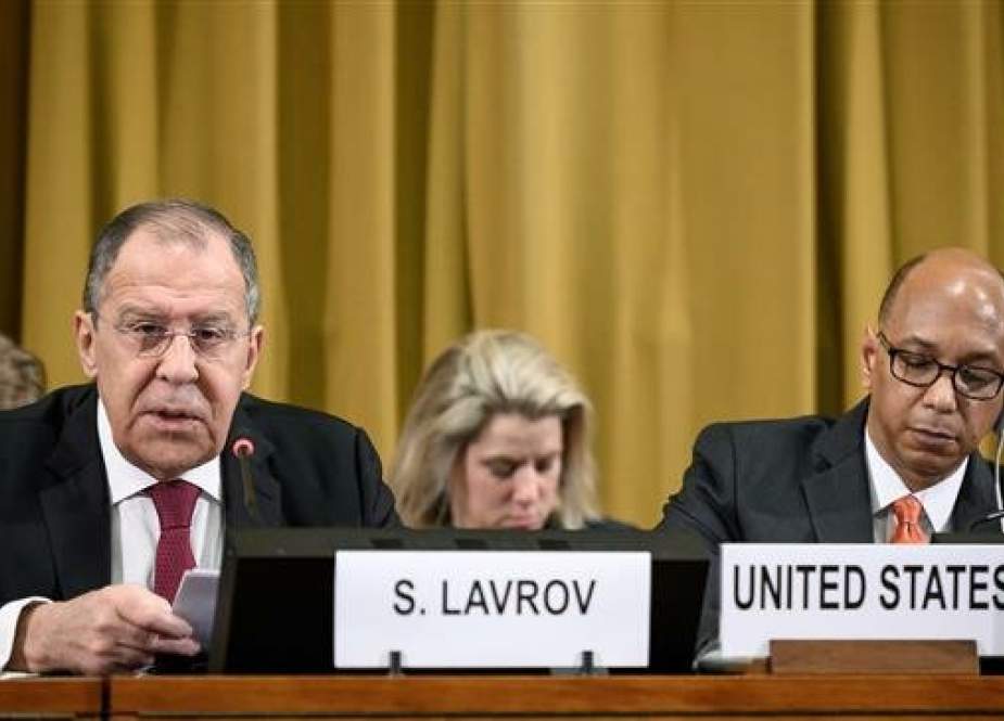 Russian Foreign Minister Sergei Lavrov delivers a speech next to US ambassador Robert Wood.jpg
