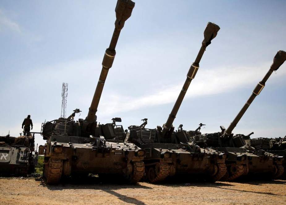 Israeli tanks stand near the border with Gaza