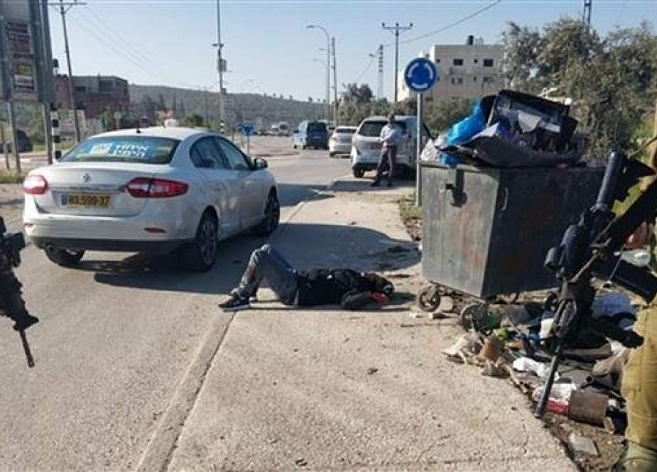 A Palestinian man is lying on the ground after being shot by an Israeli settler south of the West Bank city of Nablus on April 3, 2019. (Photo by Ma