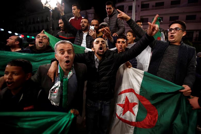 People celebrate on the streets after Algeria's President Abdelaziz Bouteflika submitted his resignation, in Algiers, Algeria April 2. Bouteflika resigned on Tuesday, succumbing to six weeks of largely peaceful mass protests driven by youth and pressure 