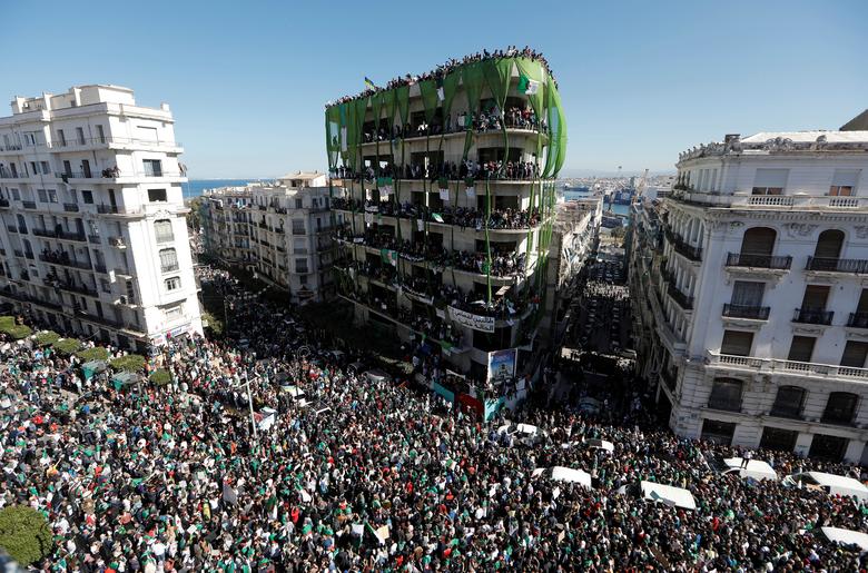 People gather during a protest over President Bouteflika's decision to postpone elections and extend his fourth term in office, in Algiers, March 15
