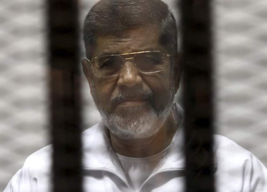 Ousted Egyptian President Mohamed Morsi is seen behind bars during his trial at a court in Cairo