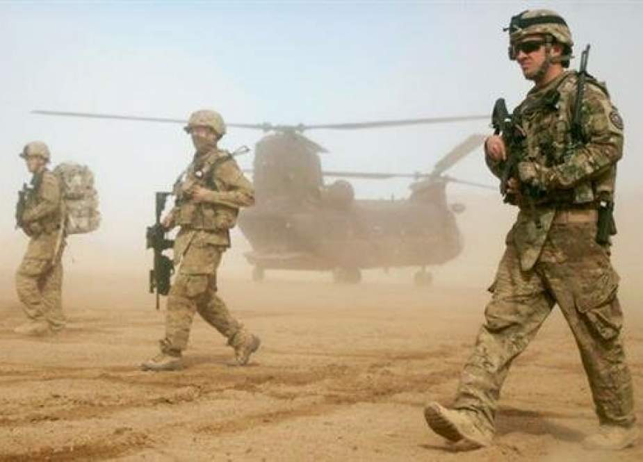 In this January 28, 2012 file photo, US soldiers walk west of Kabul, Afghanistan. (Photo by AP)