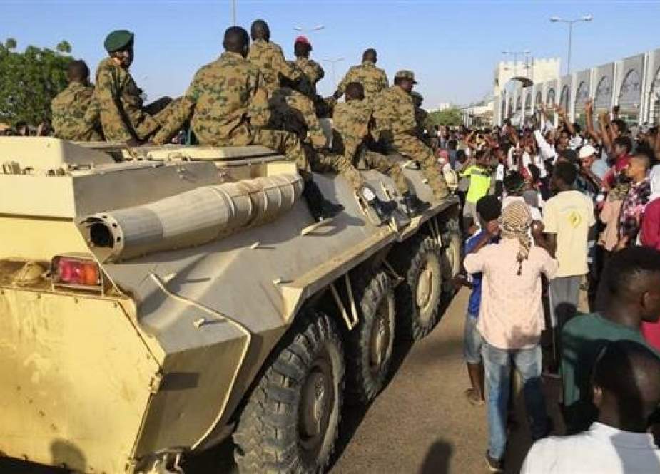 A military vehicle is passing as protesters gathered for a second day outside the military headquarters in Khartoum on April 7, 2019. (Photo by AFP)