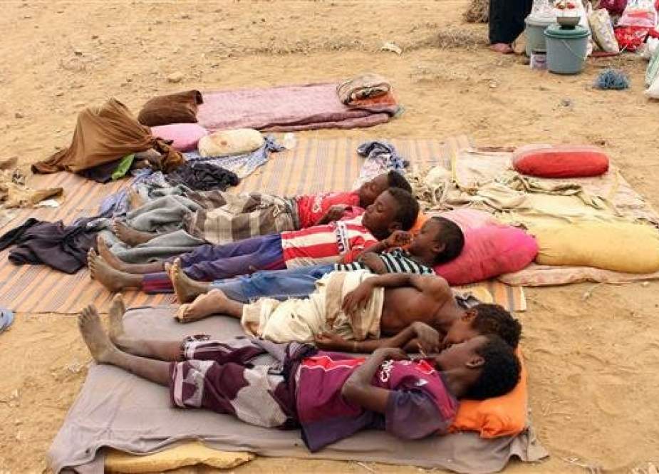 Yemeni children who fled a war waged by Saudi Arabia, gather in a makeshift camp in the district of Abs, in Yemen