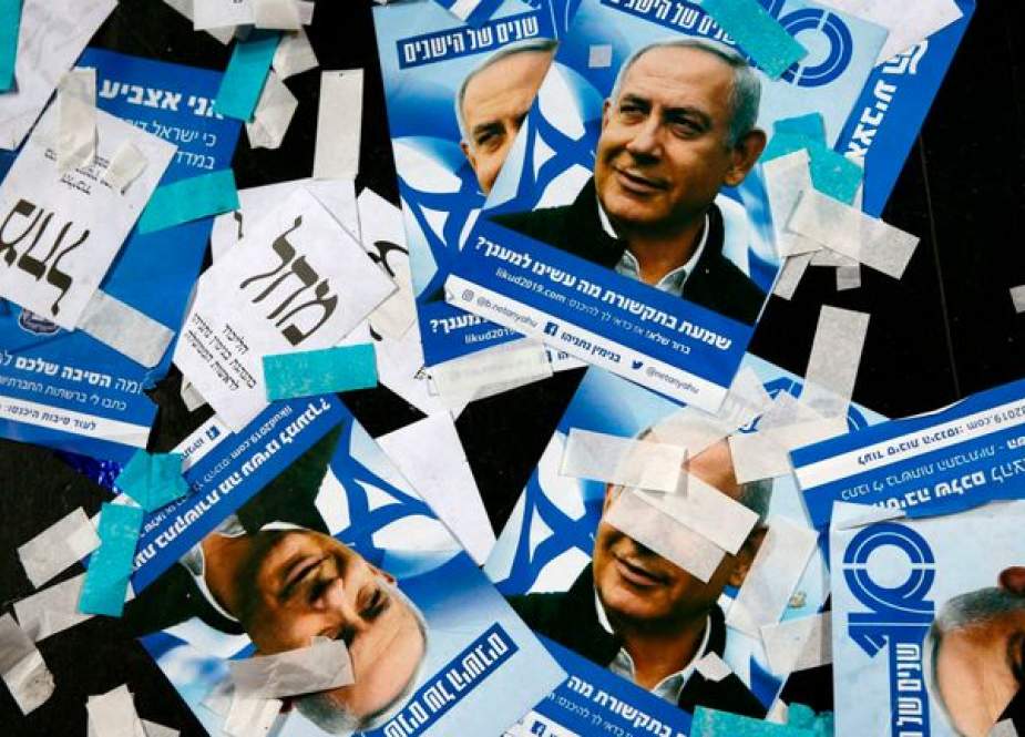 The picture taken early on April 10, 2019 shows Israeli Likud Party campaign material and posters of Prime Minister Benjamin Netanyahu strewed on the floor following election night at the party headquarters in Tel Aviv. (By AFP)