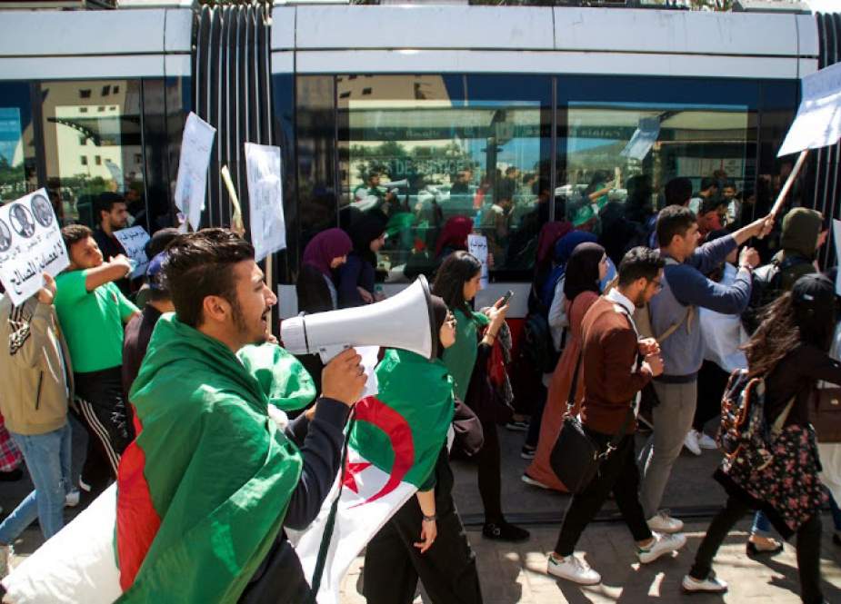 Algerians march with national flags during an anti-government protest in the northern coastal city of Oran on April 9, 2019.