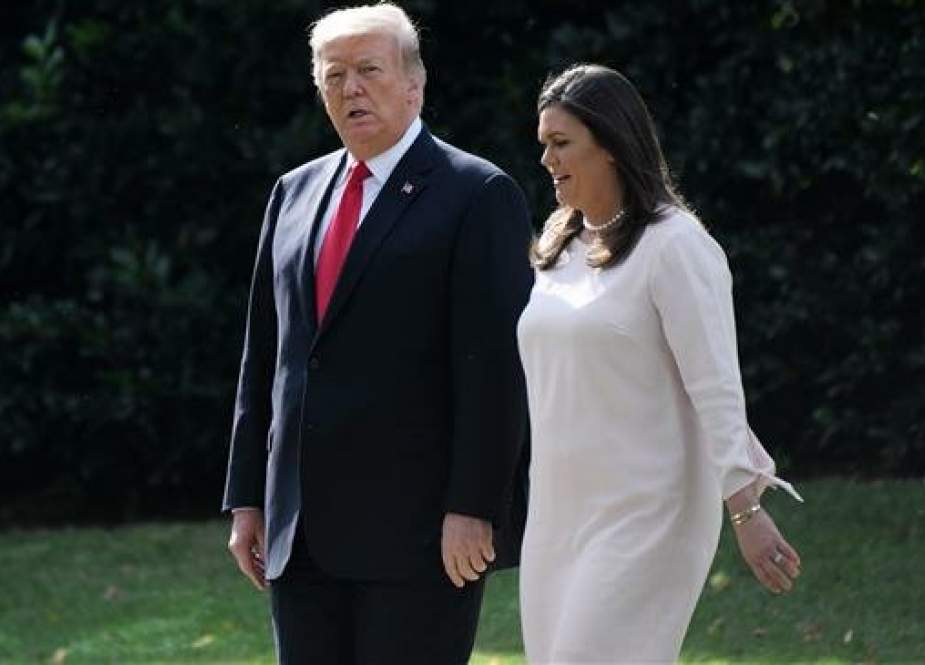 US President Donald Trump walks with White House press secretary Sarah Huckabee Sanders as they leave the White House by the South Lawn and board Marine One en route to Council Bluffs, Iowa. (AFP photo)