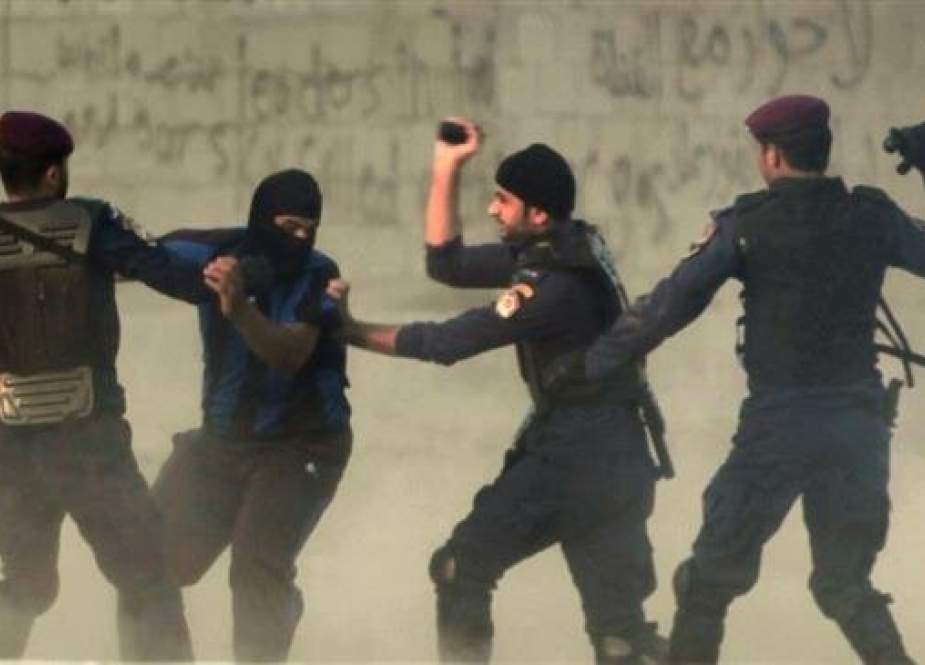 In this picture, Bahraini regime forces arrest a protester during a demonstration against the ruling Al Khalifah regime in the village of Shakhurah, west of Manama. (By AP)