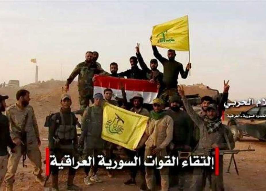 Members of the Syrian Arab Army and the Lebanese Hezbollah forces met members of Iraqi Harakat Hezbollah al-Nujaba, which is a part of the Iraqi Popular Mobilization Units (PMU), on the Syria-Iraq border following a joint operation against Daesh in November 2017. (Photo via Almanar)