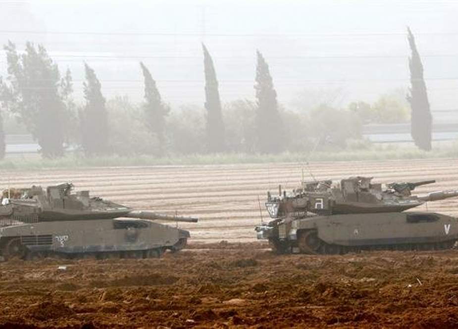 Israeli battle tanks stationed near the Gaza Strip.jpg