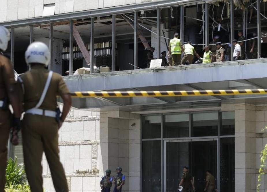 Police and forensic officials inspect the blast spot at the Shangri-La hotel in Colombo.