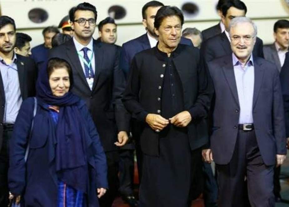 Pakistan’s Prime Minister Imran Khan is welcomed by Iranian Minister of Health and Medical Education Saeid Namaki at Tehran