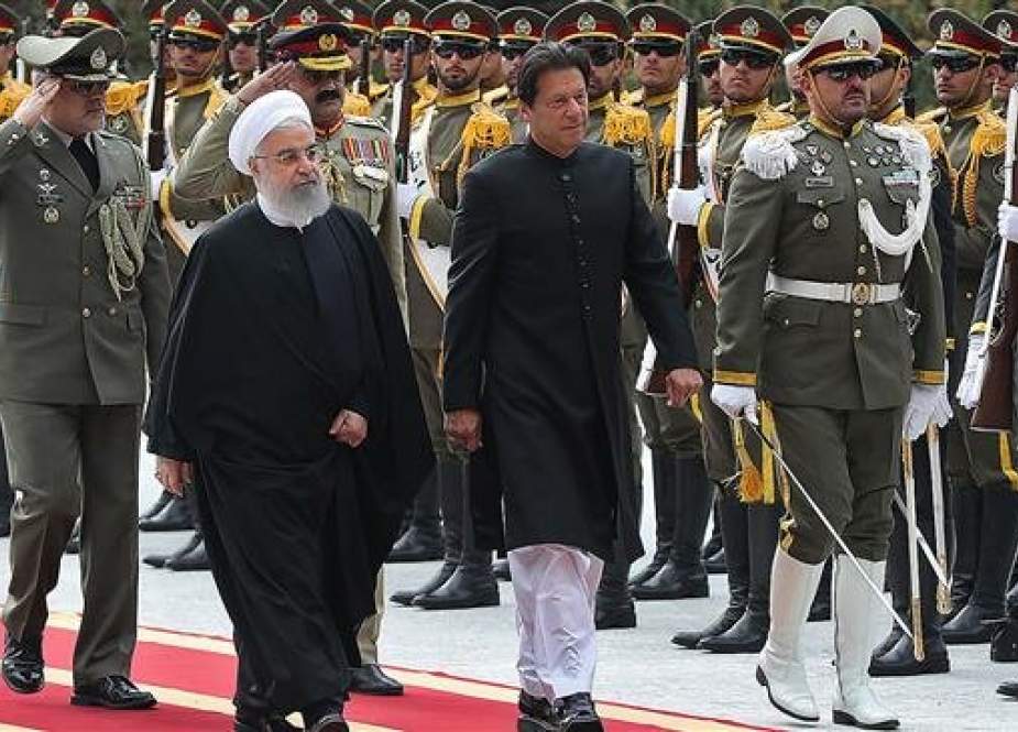 A handout picture provided by the Iranian presidency on April 22, 2019 shows Iranian President Hassan Rouhani (L) and Pakistani Prime Minister Imran Khan reviewing an honor guard in Tehran. (Photo via AFP)