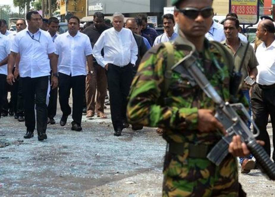 Sri Lankan Prime Minister Ranil Wickremasinghe (C) arrives to visit the site of a bomb attack at St. Anthony, in the capital Colombo, on April 21, 2019. (Photo by AFP)
