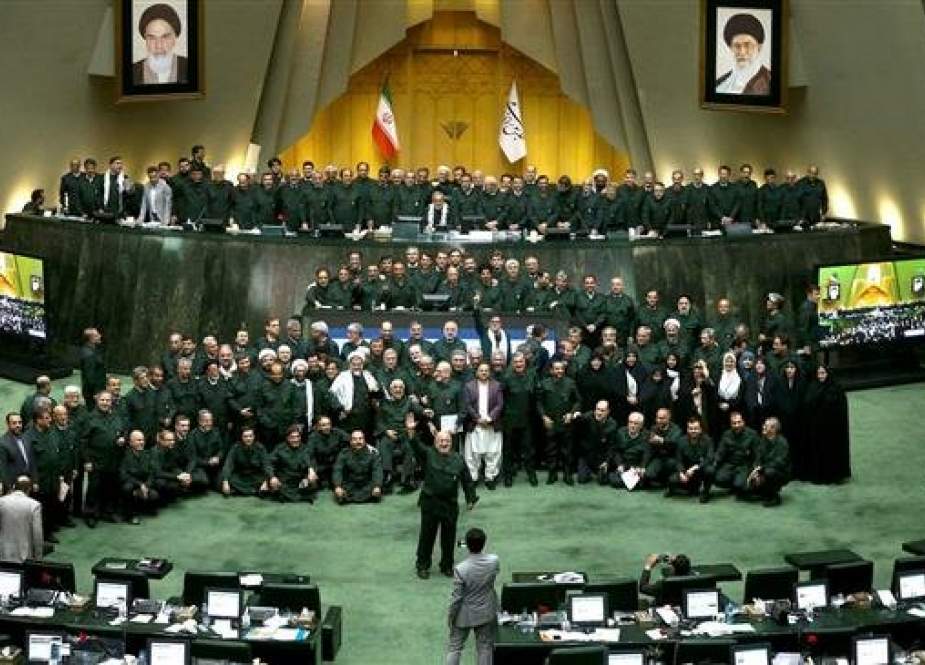 Iranian lawmakers - all wearing IRGC uniforms in support of the force - pose for a picture at the parliament in Tehran on April 9, 2019. (Photo by ICANA)