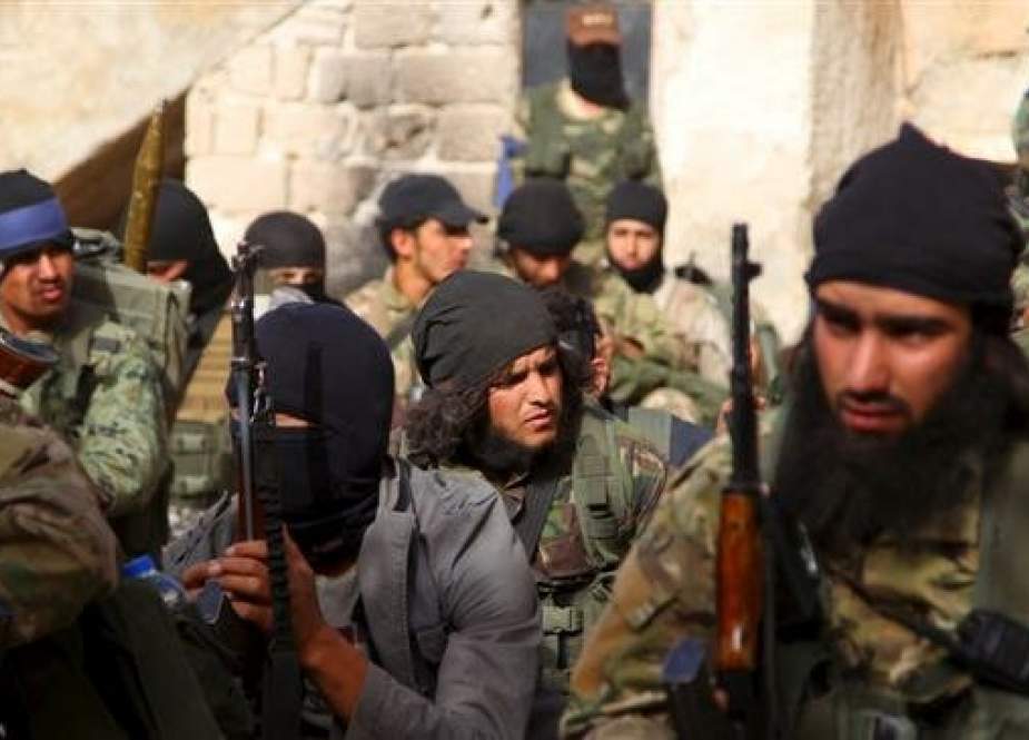 This file picture shows members of the Jabhat Fateh al-Sham, formerly known as al-Nusra Front, Takfiri terrorist group in an undisclosed location in Syria.