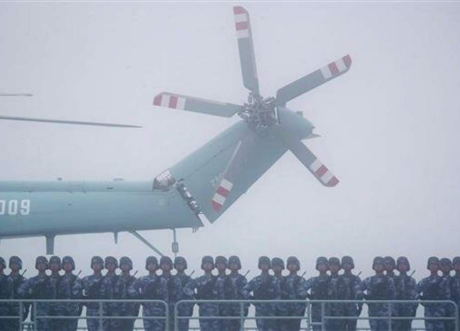 Soldiers stand on deck of the transport dock Yimen Shan of the Chinese People’s Liberation Army (PLA) Navy as it participates in a naval parade to commemorate the 70th anniversary of the founding of China’s Navy, in the sea near Qingdao, in eastern China’s Shandong Province, on April 23, 2019. (Photo by AFP)