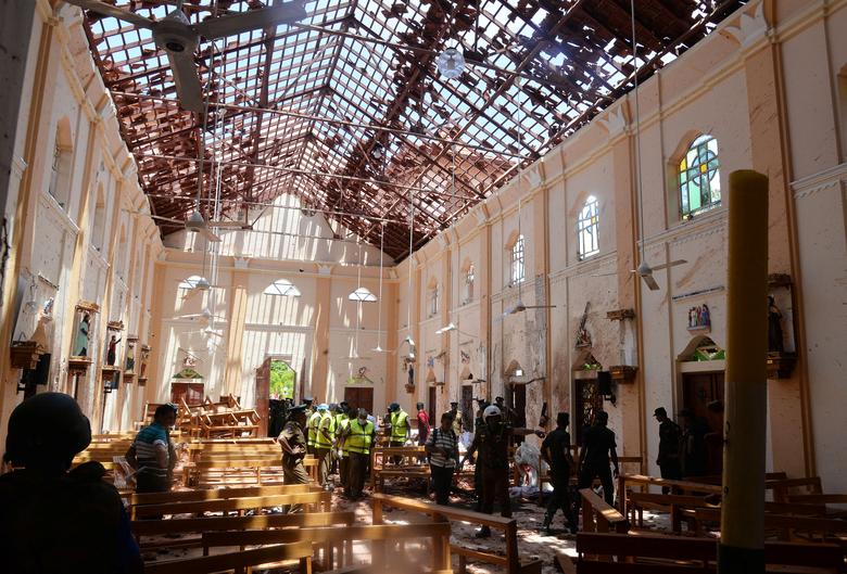 Crime scene officials inspect the site of a bomb blast inside a church in Negombo, Sri Lanka, April 21. More than 290 people were killed and at least 500 injured in bomb blasts that ripped through churches and luxury hotels in Sri Lanka on Easter Sunday,