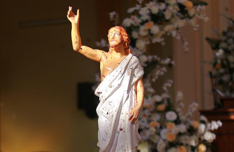 Blood stains are seen on a statue of Jesus Christ after a bomb blast inside a church in Negombo, April 21