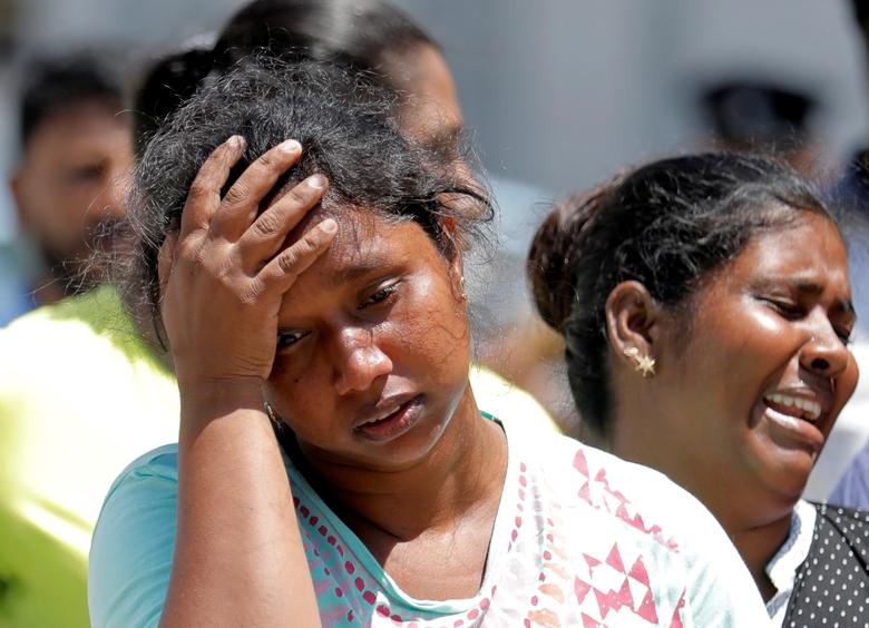 Relatives of victims react at a police mortuary, after bomb blasts ripped through churches and luxury hotels on Easter, in Colombo, April 22
