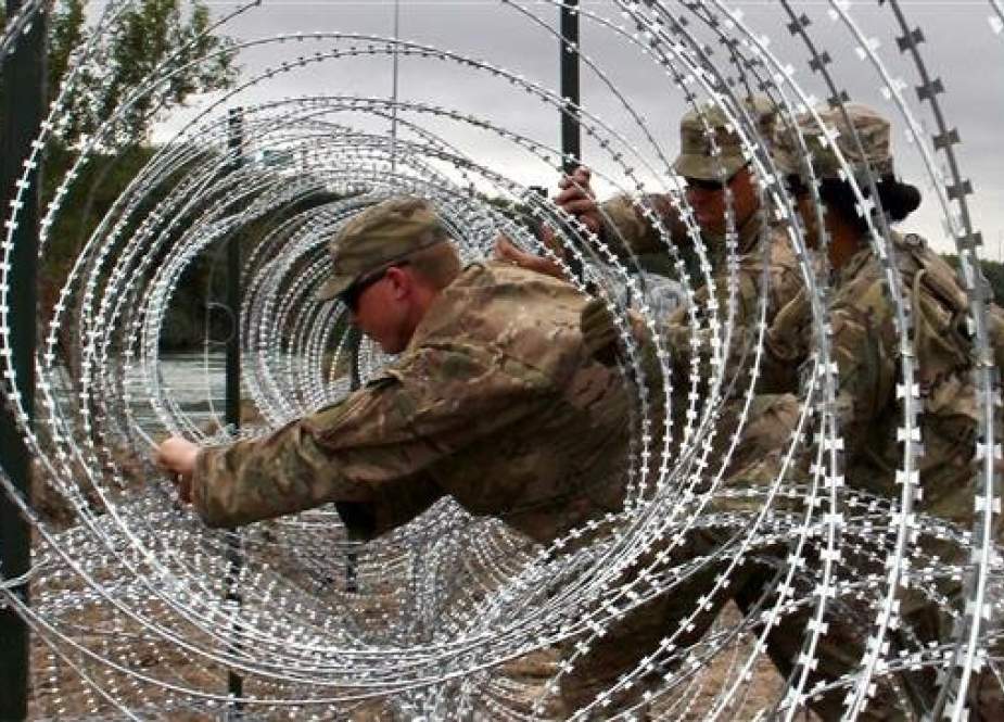 In this file photo taken on November 18, 2018, Soldiers from the Kentucky-based 19th Engineer Battalion install barbed wire fences on the banks of the Rio Grande in Laredo, Texas. (Photo by AFP)