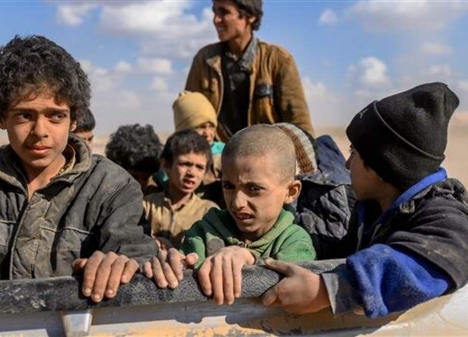 Children believed to be from the Izadi community, who were captured by militants of the Takfiri Daesh terrorist group, are pictured after being evacuated from Daesh’s holdout of Baghouz, at a screening area held by the US-backed Kurdish-led Syrian Democratic Forces (SDF), in Syria’s eastern province of Dayr al-Zawr, on March 6, 2019. (Photo by AFP)