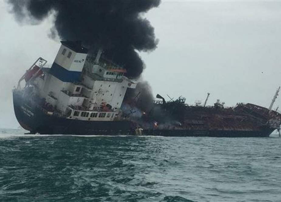 This handout file photo taken on January 8, 2019 and released by the Hong Kong Police shows smoke rising from an oil tanker as it tilts to one side in the waters near Hong Kong. (Photo by AFP)