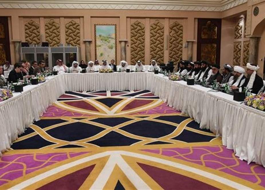 Qatari officials (C) take part in meeting between US special envoy Zalmay Khalilzad (2nd-L), the US delegation, Sher Mohammad Abbas Stanikzai (6th-R) and the Taliban delegation, in Qatar’s capital Doha on February 26, 2019. (Photo by AFP)
