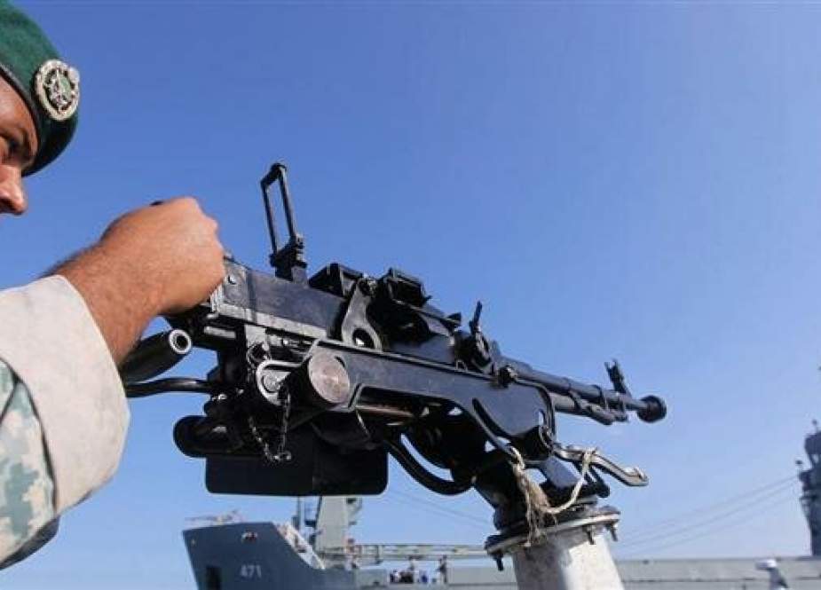 An Iranian Army soldier stands guard on a military speed boat during the "Velayat-90" navy exercises in the Strait of Hormuz in southern Iran in 2011.