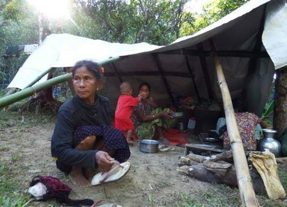 The file photo shows a Myanmar family displaced from fighting between government troops and ethnic Arakan Army at a displacement camp housing over 700 people in Kyauktaw township in Rakhine state on December 23, 2018. (By AFP)