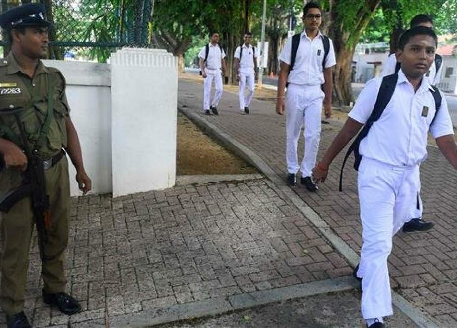 Sri Lankan police stand guard as school students return to classes with the re-opening of educational centers across the country after the Easter attacks in Colombo, Sri Lanka, on May 6, 2019. (Photo by AFP)