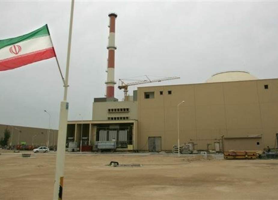 In this file photo taken on April 03, 2007 an Iranian flag flutters outside the building housing the reactor of the Bushehr nuclear power plant in the Iranian port city of Bushehr. (Photo by AFP)