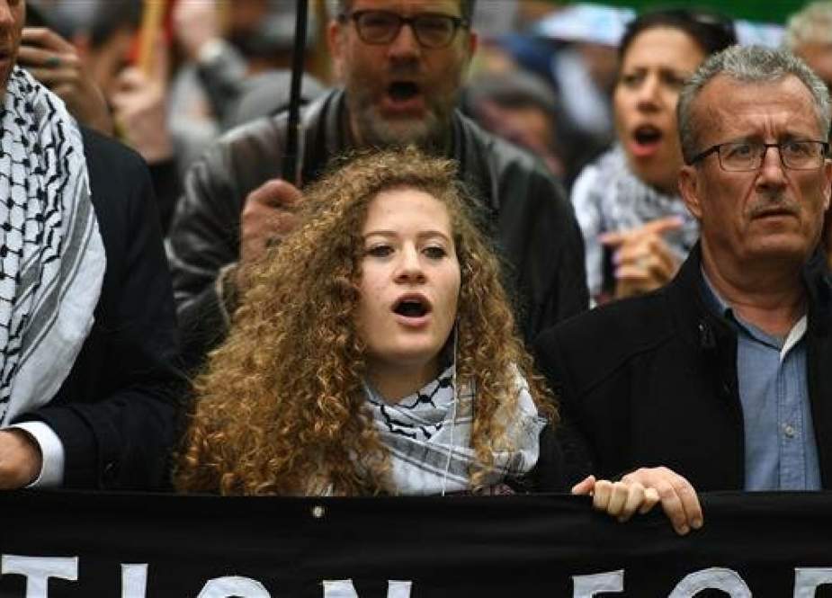 Palestinian activist Ahed Tamimi (C) joins a march calling for justice for Palestinians amid a growing threat of further war in the Middle East moves through the London streets of central London on May 11, 2019. (Photo by AFP)