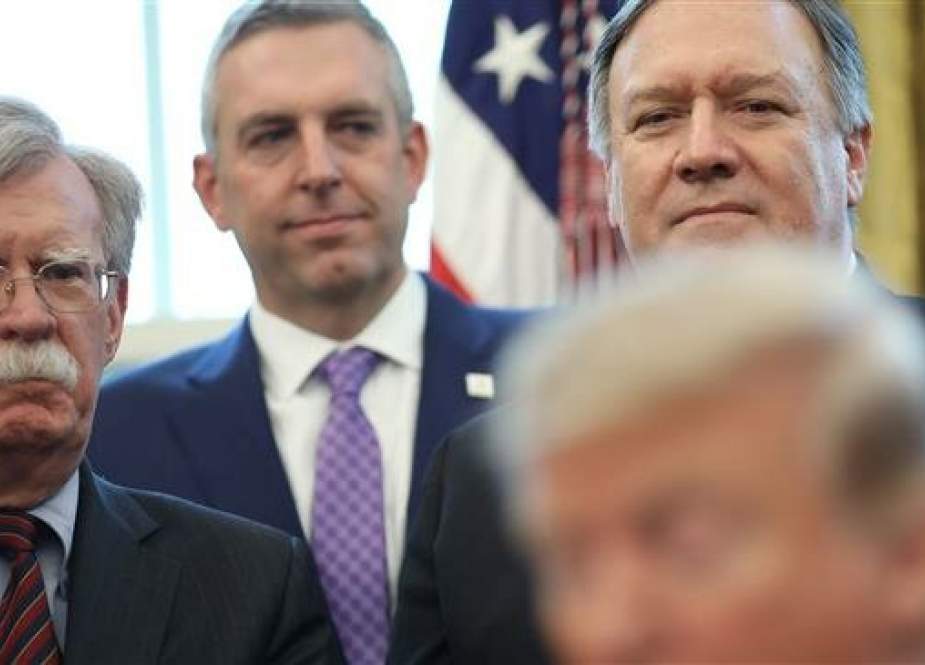 US National Security Advisor John Bolton (L) and Secretary of State Mike Pompeo (R) listen as US President Donald Trump speaks before signing a National Security Presidential Memorandum in the Oval Office February 7, 2019 in Washington, DC. (Photo by AFP)