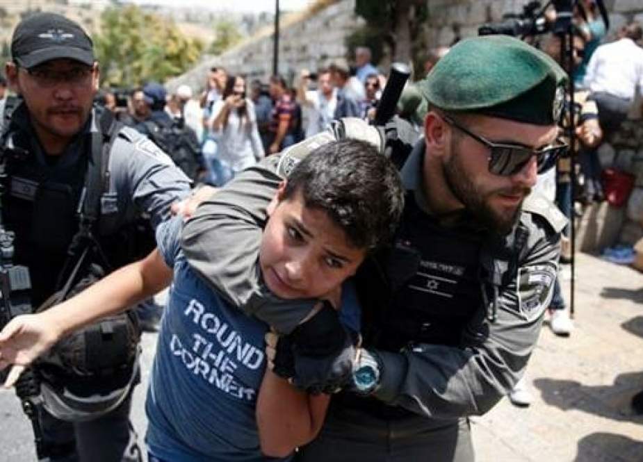Israeli forces arrest a Palestinian youth during a demonstration at the al-Aqsa mosque.jpg