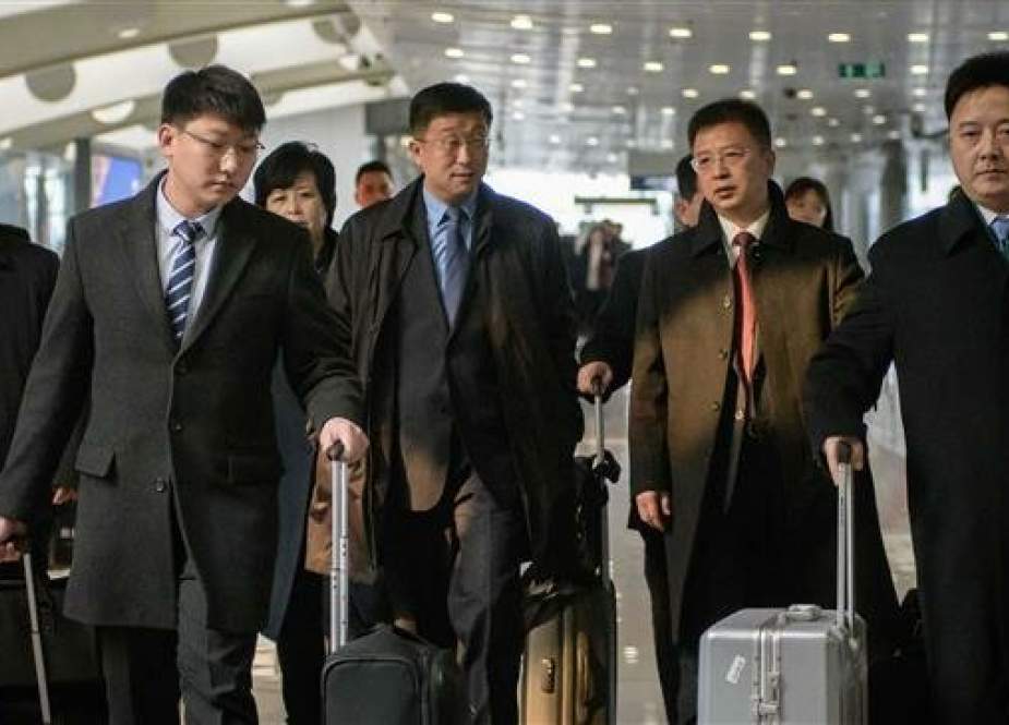 This file photo taken on February 19, 2019 shows a man believed to be North Korean negotiator Kim Hyok-chol (center left-blue tie) after arriving on an Air Koryo flight from Pyongyang, at Beijing international airport. (Photo by AFP)