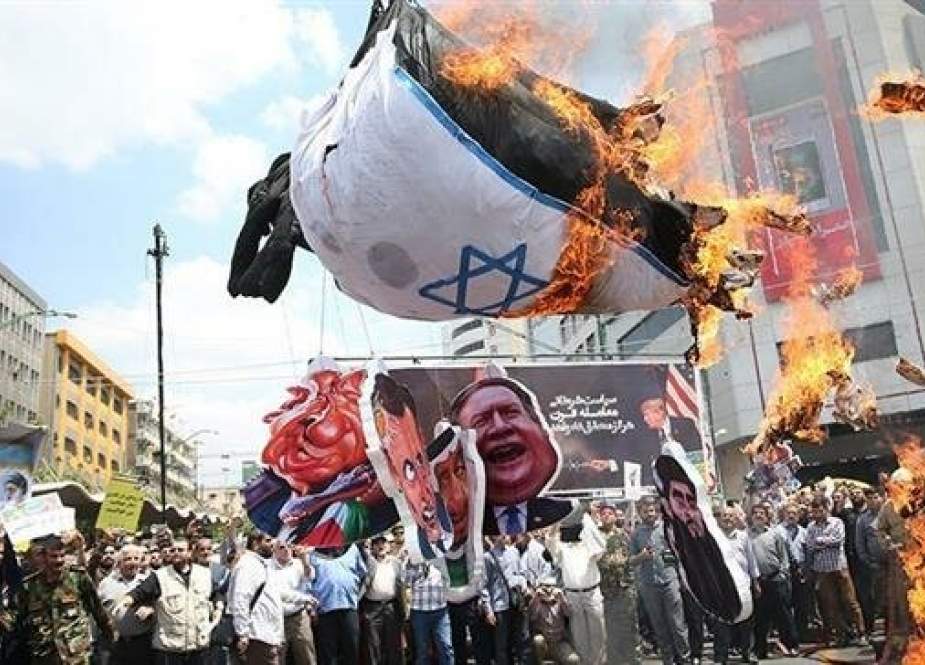 Protesters in Tehran burn an Israeli flag during International Quds Day rallies, May 31, 2019.
