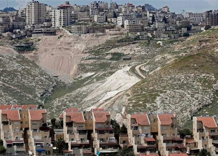 This picture taken from the Israeli settlement of Maale Adumim shows some buildings of Maale Adumim in the occupied West Bank (bottom) and the outskirts of Jerusalem al-Quds (up) on April 18, 2019. (By AFP)