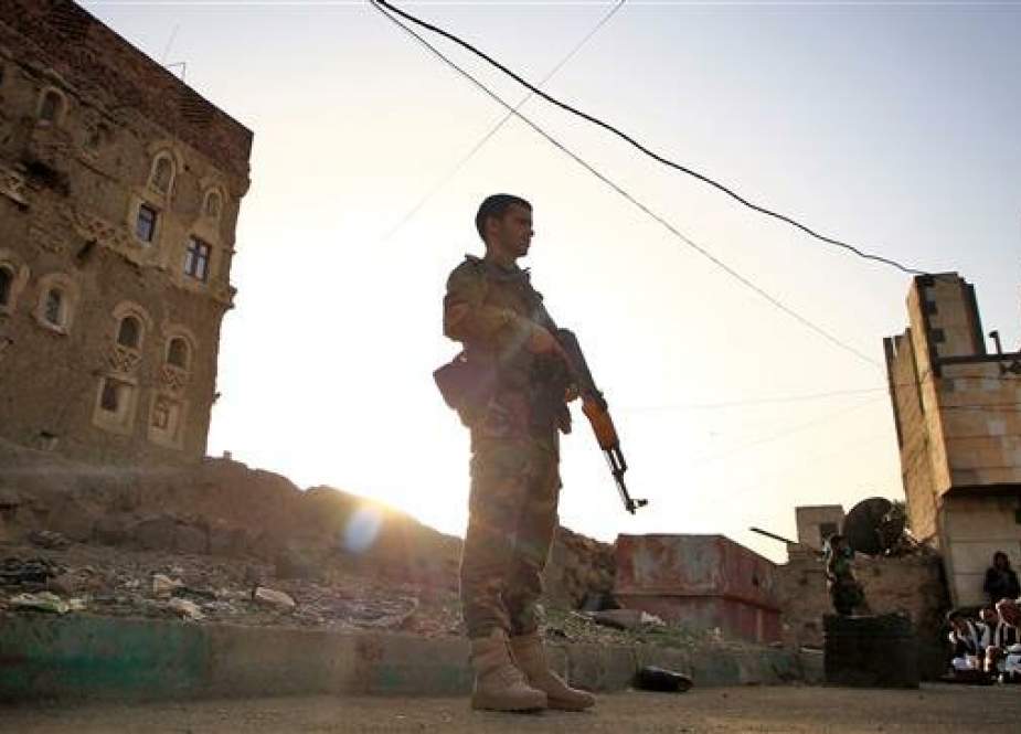 Yemeni security forces stand guard as Muslim worshippers perform Eid al-Fitr prayers at a square in the capital Sana