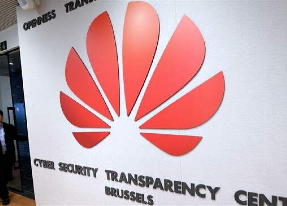 A man enters as guests tour the European Huawei Cyber Security Transparency Center during its opening in Brussels on March 5, 2019. (Photo by AFP)