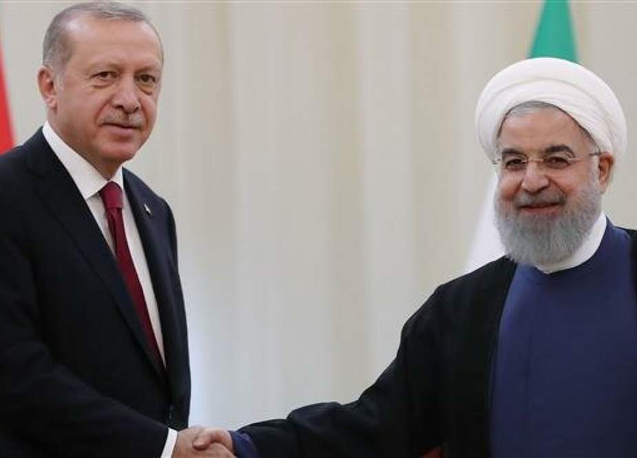 A handout picture taken and released on September 7, 2018 in Tehran by the Turkish Presidential press service shows Turkish President Recep Tayyip Erdogan (L) shaking hands with Iranian President Hassan Rouhani. (Photo by AFP)