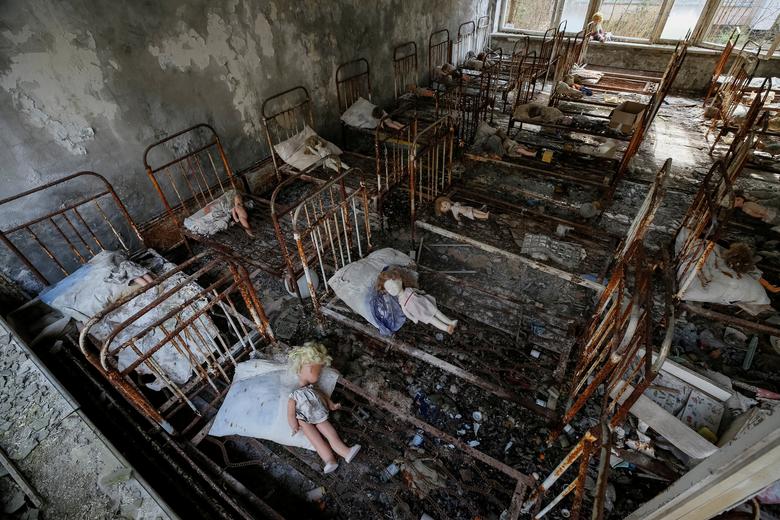 Dolls, which were placed by a visitor, lie in beds at a kindergarten in the abandoned city of Pripyat near the Chernobyl nuclear power plant in Ukraine
